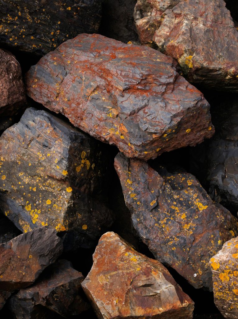 A pile of rocks with brown and yellow spots